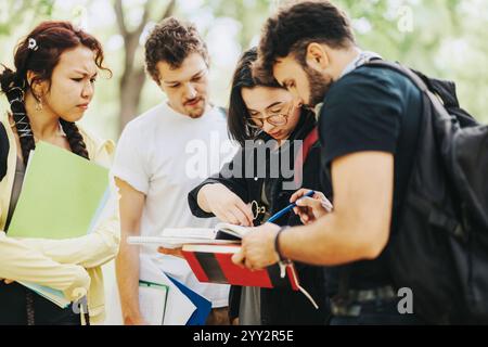 Multicultural students discussing school project in a park setting study group Stock Photo