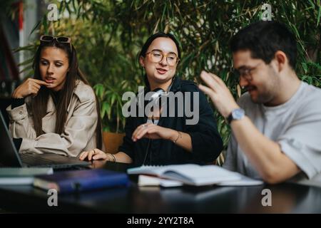 High school friends collaborating on assignments in a cozy coffee bar Stock Photo
