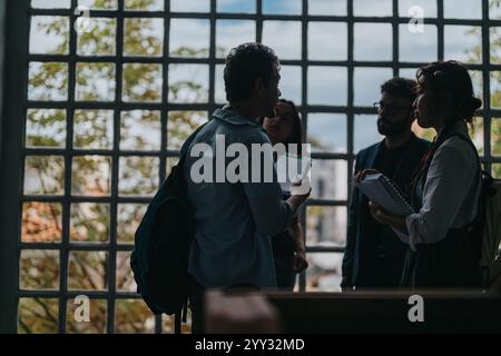 Students engaging in a thoughtful discussion with their professor Stock Photo