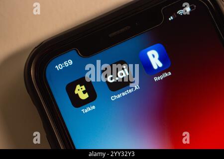 Talkie, Character.AI and Replika icons are displayed on an iPhone. AI-powered conversational apps and services related to virtual characters concept Stock Photo
