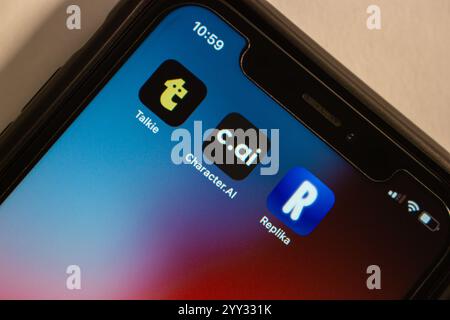 Talkie, Character.AI and Replika icons are displayed on an iPhone. AI-powered conversational apps and services related to virtual characters concept Stock Photo