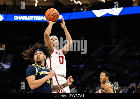 Michigan guard Tre Donaldson (3) shoots around Purdue guard Myles ...