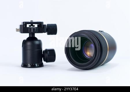 Professional Camera Lens and Tripod Ball Head on White Background Stock Photo