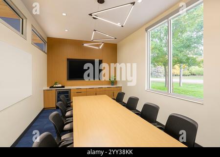 Conference room in apartment complex with wall mounted television Stock Photo