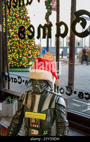 Photo of a Darth Vader decoration on display with Santa cap in game shop in the historic old town area. Stock Photo