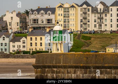 Port Erin, Rushen, Isle of Man - May 18, 2023: View of the pier and lighthouse with the houses on the promenade in the background Stock Photo