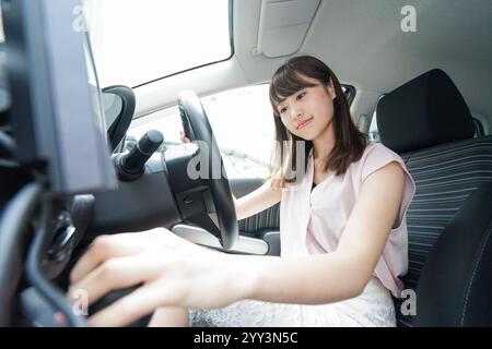 Woman using car navigation system Stock Photo