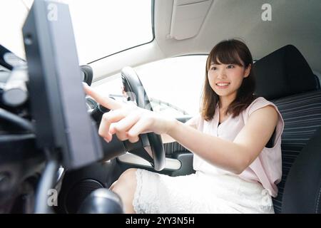 Woman using car navigation system Stock Photo