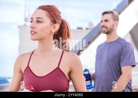 Fit Couple Taking a Break During Outdoor Workout Stock Photo