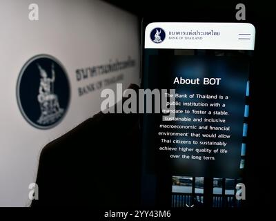 Germany. 24th June, 2024. In this photo illustration, a person is holding a cellphone with the webpage of Thai financial institution Bank of Thailand (BOT) in front of logo. (Credit Image: © Timon Schneider/SOPA Images via ZUMA Press Wire) EDITORIAL USAGE ONLY! Not for Commercial USAGE! Stock Photo