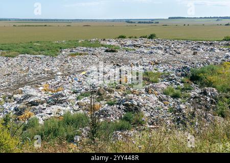 Bird's eye view of a city dump or landfill. Pile of plastic garbage, food waste and other garbage, top view. Pollution concept. The concept of ecology Stock Photo