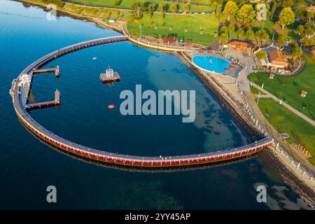 Aerial view of a swimming enclosure and parkland along a coastal city waterfront at Geelong in Victoria, Australia Stock Photo