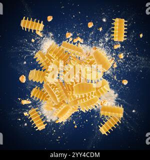 Radiatori pasta exploding with flour and whole wheat grains on blue background Stock Photo