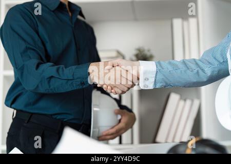 Professional Engineers and Architects Collaborating on Modern Building Design Project Stock Photo