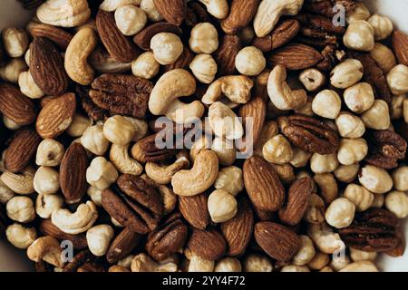 A variety of mixed nuts, including almonds, cashews, pecans, and hazelnuts, showcasing a rich blend of textures and flavors Perfect for snacking, baki Stock Photo