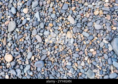 High-resolution image of assorted smooth pebbles in varying sizes and shades, creating a natural, textured background. Ideal for design, decoration, o Stock Photo