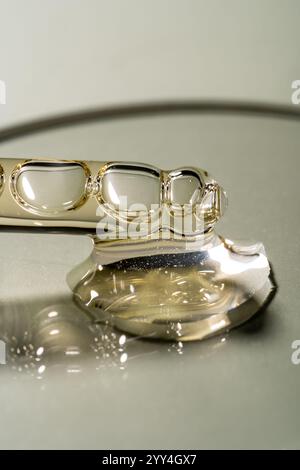 A close-up image showcases transparent liquid bubbles on a reflective surface, highlighting their mesmerizing shapes and delicate texture. Ideal for a Stock Photo