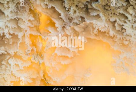 A stunning abstract close-up of backlit onyx stone, showcasing its intricate patterns and warm hues. Ideal for backgrounds or design projects featurin Stock Photo