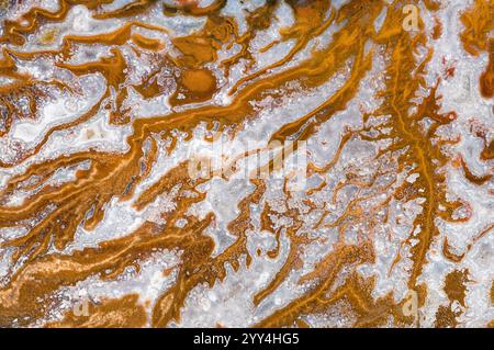 Artistic close-up showcasing intricate patterns and textures formed by rust and corrosion on a metallic surface. Highlights the blend of earthy tones Stock Photo