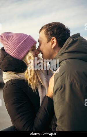 Young married couple, a man and a woman, sharing a close and affectionate moment while walking in Wroclaw, Poland during the cool season. They are loo Stock Photo