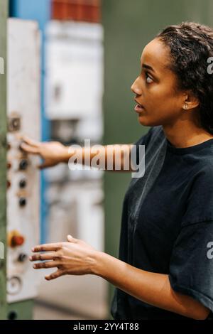 Female worker in uniform working at distribution warehouse Stock Photo