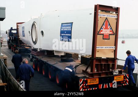 Orkney - April 1987 - The central portion of the 60 metre blade made by British Aerospace being transported at Kirkwall, Orkney on it's way to the Burgar Hill windfarm. Scotland. Stock Photo