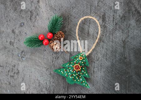 Handmade Christmas decoration  made of felt and seed bead. Black background with space for text. Stock Photo