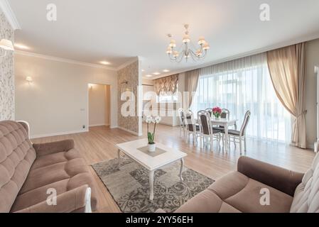 A sophisticated home living and dining space featuring tasteful decor, luxurious furniture, and warm lighting. Ideal for a peaceful yet stylish home i Stock Photo