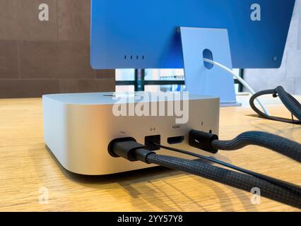 Paris, France - Dec 10, 2024: The rear view of the new Mac Mini M4 showcases its versatile ports, including USB-C, Thunderbolt 4, HDMI, Ethernet with 10GbE support, and a power connector. Stock Photo