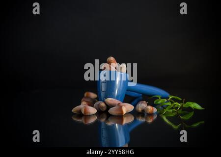 hazelnuts with nutcracker isolated on black background. Stock Photo