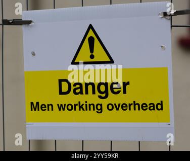 A sign warning about men working overhead. Stock Photo