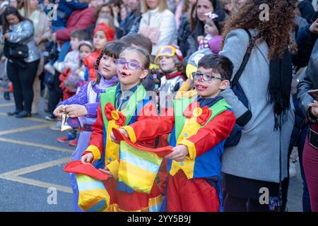 A group of kids wearing party hats and holding balloons Stock Photo - Alamy