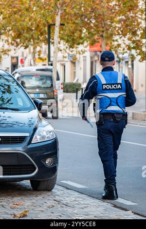 Police officer in uniform on the road traffic. Policeman back view maintain public order in the streets in Albania. Inspector of traffic police highwa Stock Photo