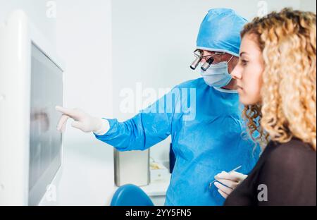 Male doctor dentist on the computer looking at a x-ray Stock Photo