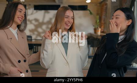 Happy smiling laughing joyful positive friendly business women people colleagues females multiracial multiethnic girls businesswomen diversity Stock Photo