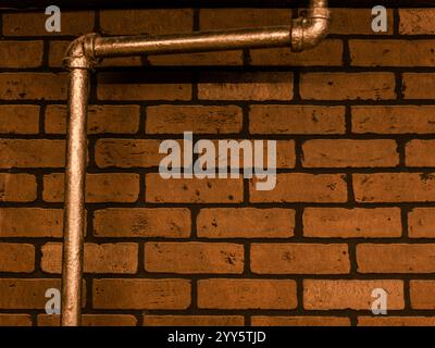 Brick Interior Facade with Copper Water Pipes Stock Photo