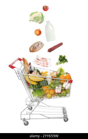 Groceries falling into shopping cart on white background Stock Photo