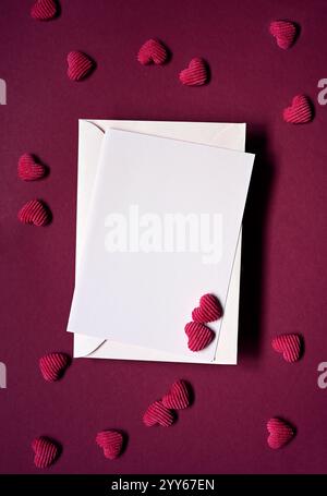 Envelope and red hearts on red background. Top view. Valentines day. Stock Photo