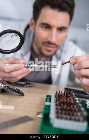 close up of young man repairing motherboard Stock Photo