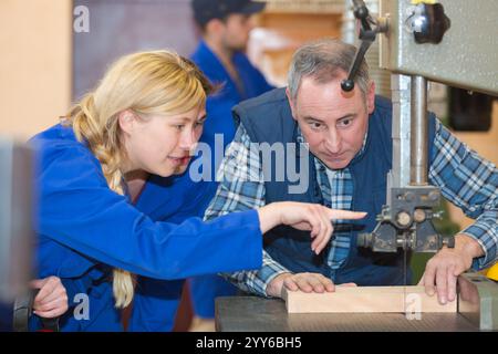 operating drilling machine making furniture in woodworking shop Stock Photo
