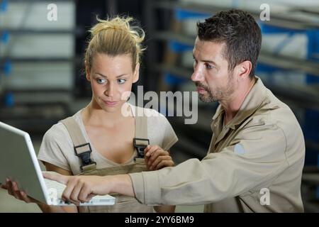 warehouse managers using laptop in warehouse Stock Photo