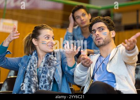 animated sport supporters wearing facepaint making hand gestures Stock Photo