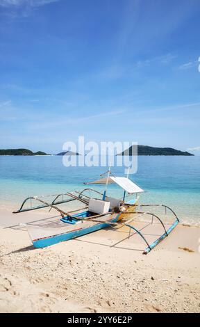 Bangka fishing boat on the beach of Inapupan Island in the Philippines. Stock Photo