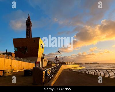 Blackpool Tower and Golden wedding chapel on the seafront at Blackpool. Winter evening light on the promenade with Central Pier in the distance Stock Photo