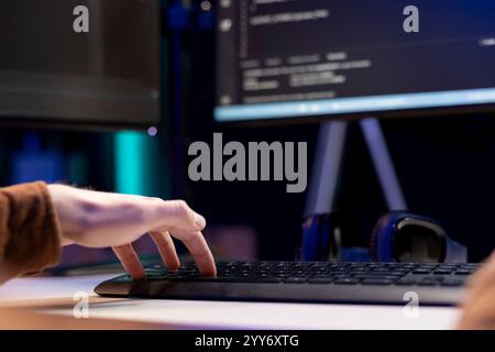 Computer technician working from home, designing and developing software applications. IT specialist typing on PC keyboard, implementing and maintaining company systems, close up Stock Photo