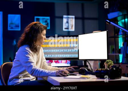 Freelancer works on isolated screen desktop computer on digital portfolio showcasing edited images. Photo editor selecting best photographs using retouching application on mockup display Stock Photo