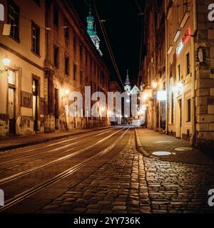 Lviv old town at night. Empty street with tram tracks in the city centre. Stock Photo