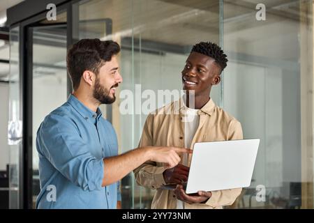 Team of two busy business men working standing in office using laptop. Stock Photo