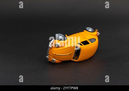 Classic toy car on black background. Car insurance concept. Stock Photo