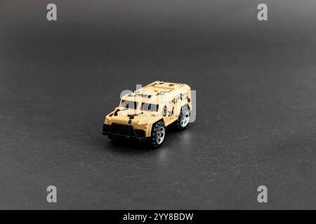 Tan Military Armored Vehicle Model on Black Background Stock Photo